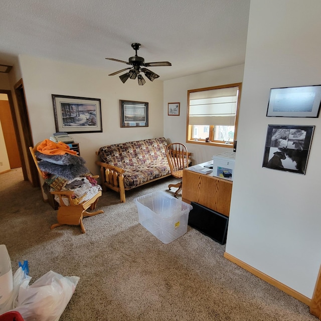 living room with a textured ceiling, carpet floors, and ceiling fan