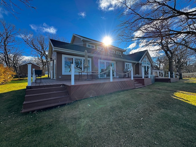 back of house featuring a wooden deck and a yard