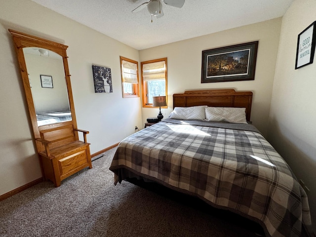 carpeted bedroom with ceiling fan and a textured ceiling