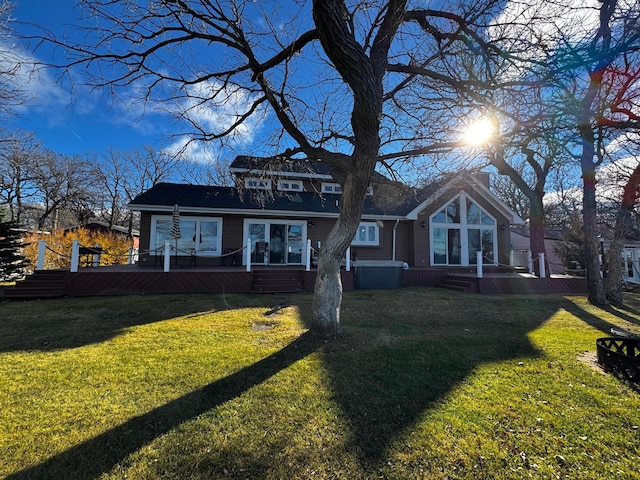 view of front of home featuring a front yard and a wooden deck