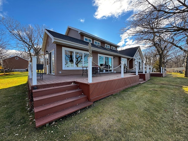 rear view of house featuring a lawn and a wooden deck