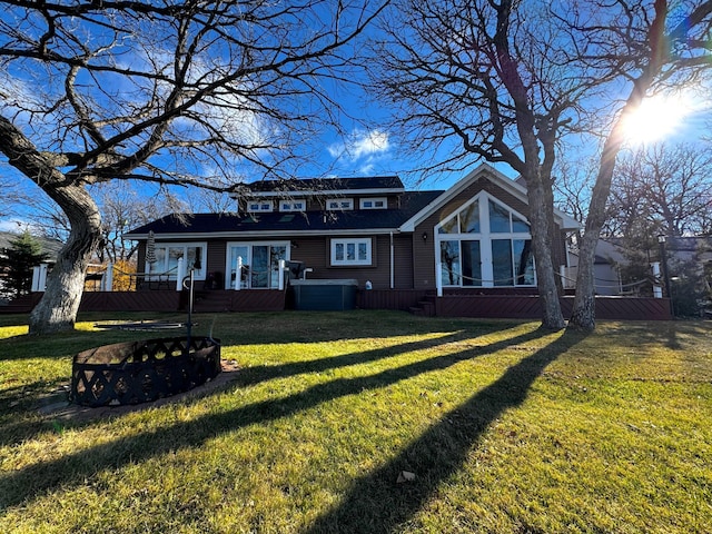 view of front of house featuring a wooden deck and a front yard