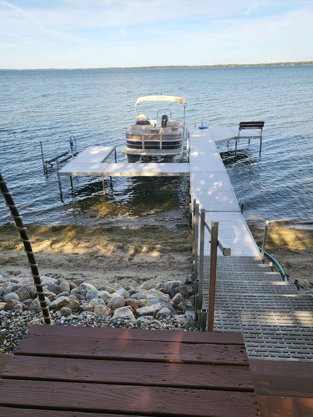 dock area with a water view and boat lift