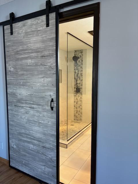 interior space with a barn door and wood finished floors