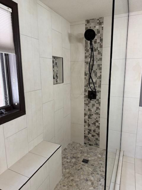 bathroom with tiled shower