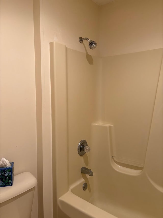 bathroom featuring toilet and  shower combination