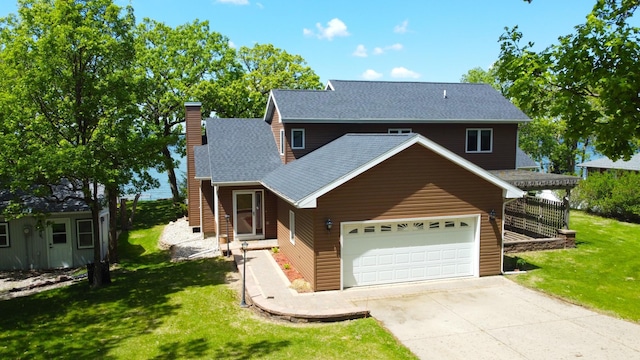 145 Bay View Rd, Ottertail, MN 56571 - view of front of property featuring a chimney, a garage, driveway, a shingled roof, and a front yard