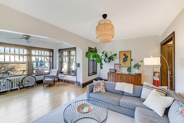 living room with light wood-type flooring and ceiling fan