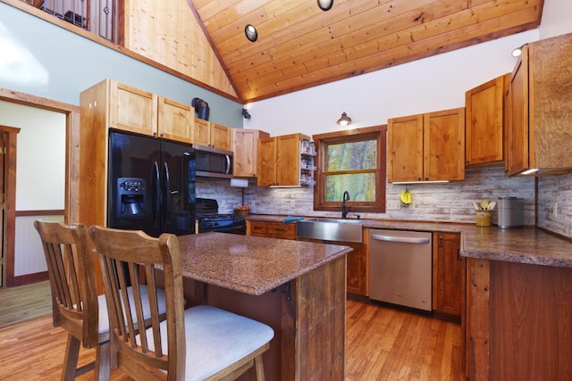 kitchen featuring black appliances, sink, light hardwood / wood-style floors, wooden ceiling, and high vaulted ceiling