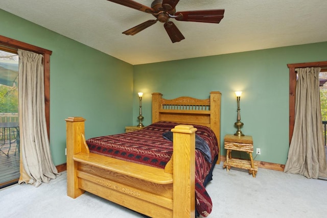 bedroom featuring ceiling fan, carpet flooring, a textured ceiling, and access to exterior