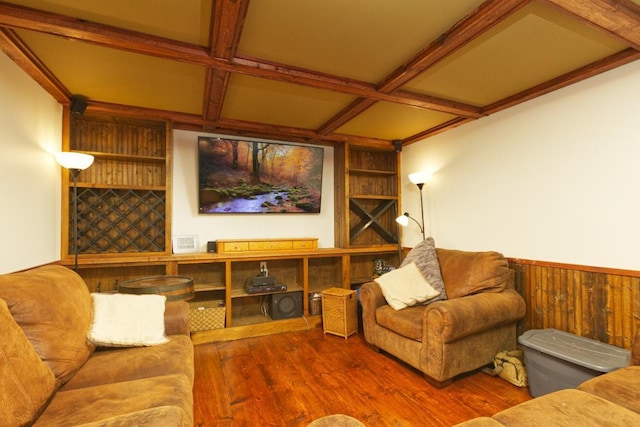 home theater with beamed ceiling, coffered ceiling, wood-type flooring, and wood walls