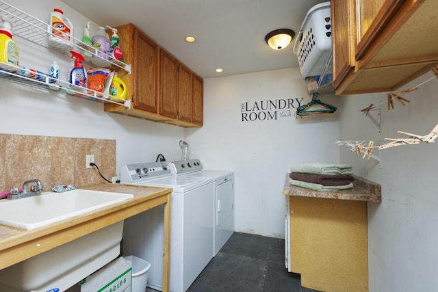 clothes washing area with cabinets, independent washer and dryer, and sink