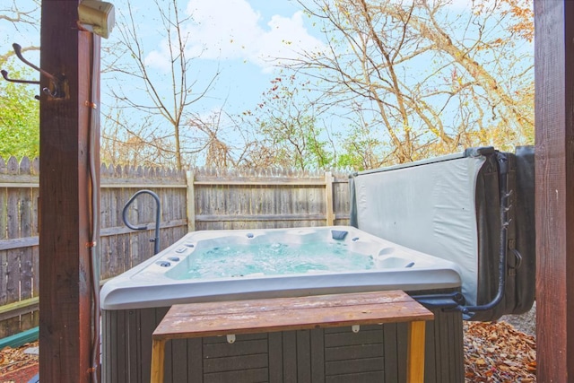 wooden terrace with a hot tub