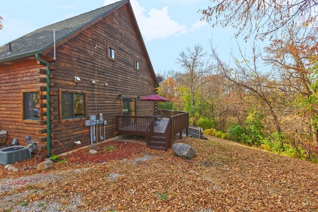 view of side of home featuring central AC and a wooden deck