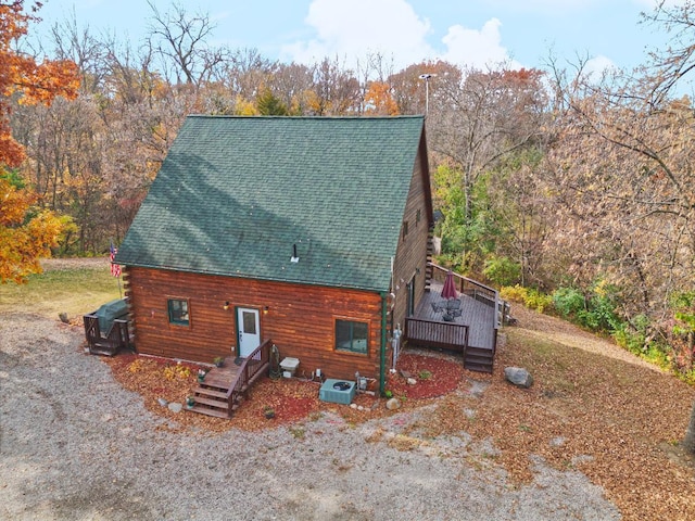 back of property with a wooden deck and cooling unit