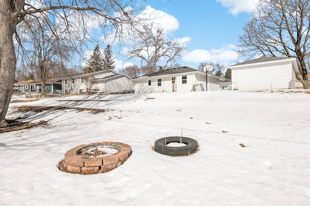 yard covered in snow featuring a fire pit