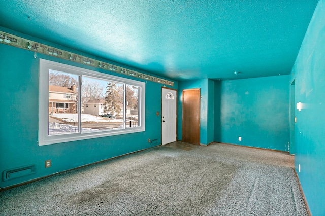 empty room featuring a textured ceiling