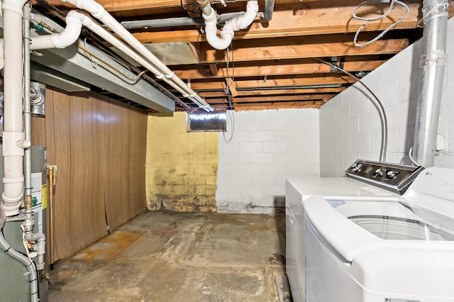 washroom with laundry area, washing machine and dryer, and gas water heater