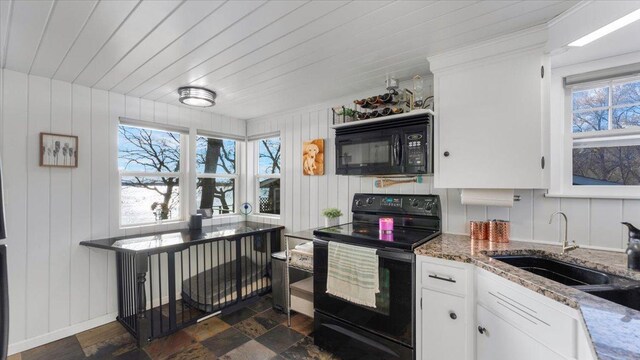 11470 Forada Beach Rd SE, Alexandria, MN 56308 - kitchen with decorative backsplash, light stone countertops, white cabinetry, a sink, and black appliances