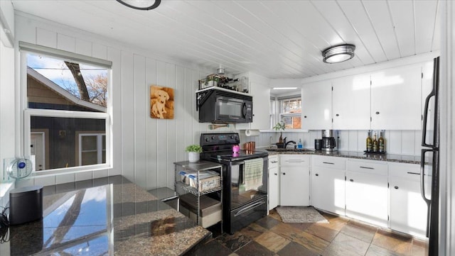 11470 Forada Beach Rd SE, Alexandria, MN 56308 - kitchen featuring a sink, dark stone countertops, white cabinetry, stone finish flooring, and black appliances