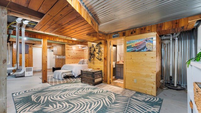 11470 Forada Beach Rd SE, Alexandria, MN 56308 - bedroom with concrete flooring and wood walls