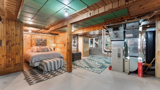 11470 Forada Beach Rd SE, Alexandria, MN 56308 - bedroom with concrete flooring, wood walls, heating unit, and visible vents