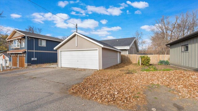 11470 Forada Beach Rd SE, Alexandria, MN 56308 - view of side of property featuring a detached garage, fence, an outbuilding, and board and batten siding