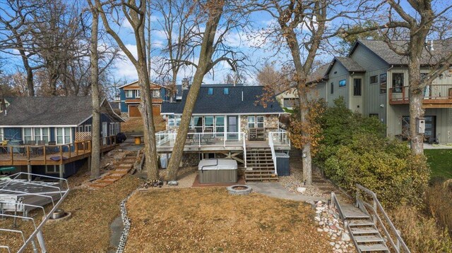 11470 Forada Beach Rd SE, Alexandria, MN 56308 - rear view of property with a wooden deck, roof with shingles, stairs, a hot tub, and a residential view