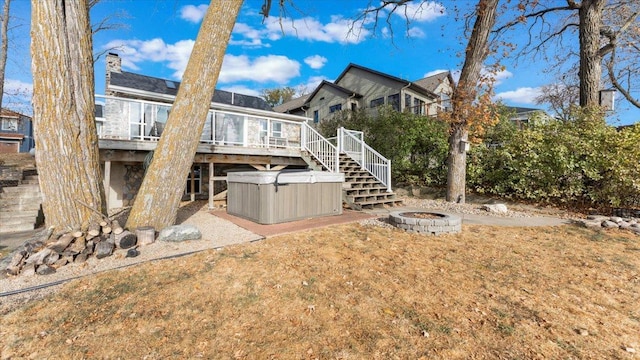 11470 Forada Beach Rd SE, Alexandria, MN 56308 - rear view of house with an outdoor fire pit, a wooden deck, stairs, a sunroom, and a hot tub