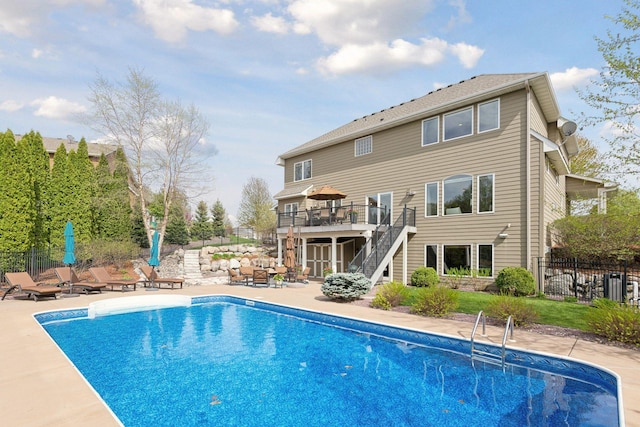 rear view of house featuring a fenced in pool, stairway, a patio area, fence, and a deck