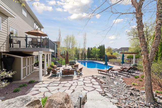 view of swimming pool featuring an outdoor fire pit, stairway, a fenced in pool, and a patio