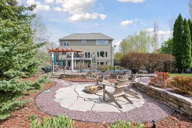 back of property featuring an outdoor fire pit, fence, a patio, and a pergola