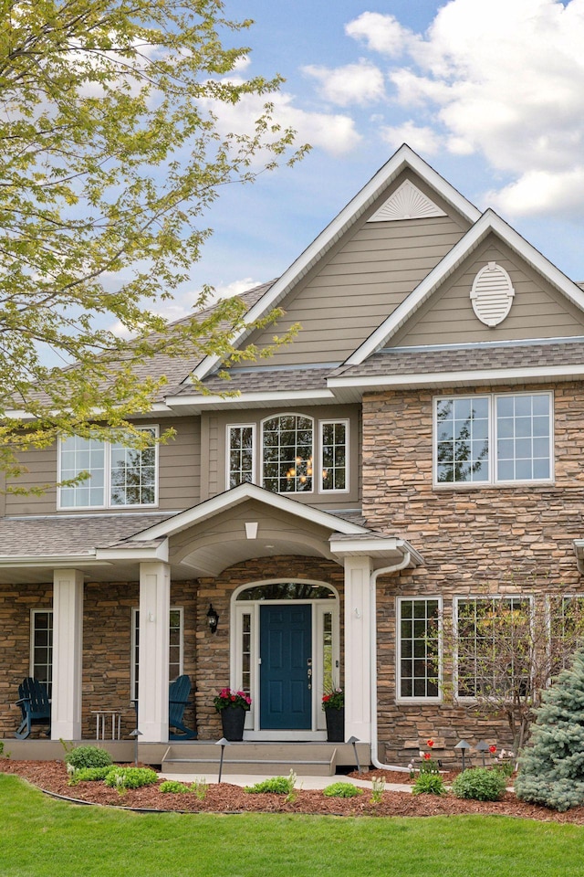 view of front facade with stone siding and a porch