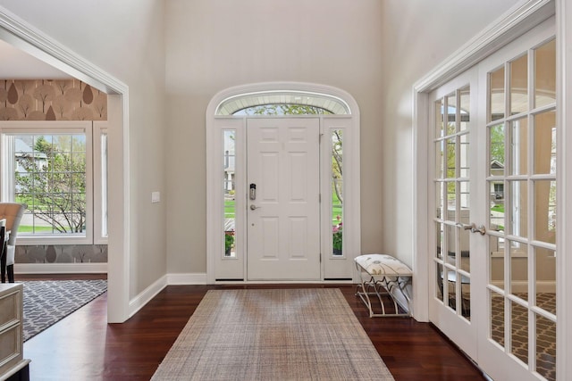 entrance foyer featuring baseboards and dark wood-type flooring