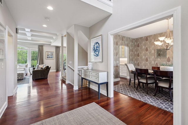 foyer entrance with arched walkways, recessed lighting, baseboards, dark wood-style floors, and an inviting chandelier