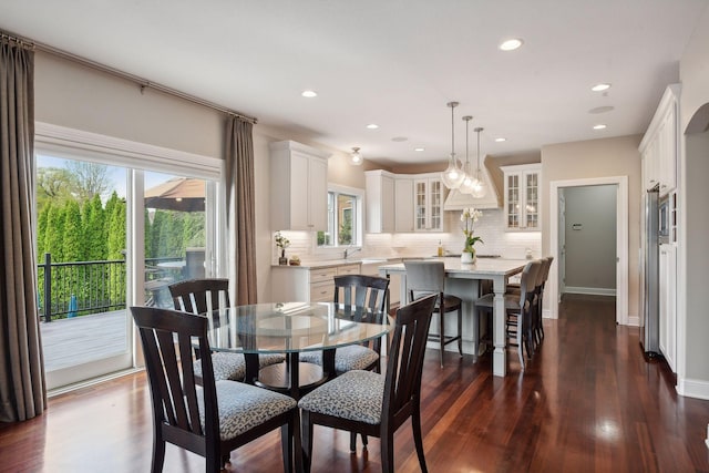 dining room featuring recessed lighting, dark wood finished floors, and baseboards