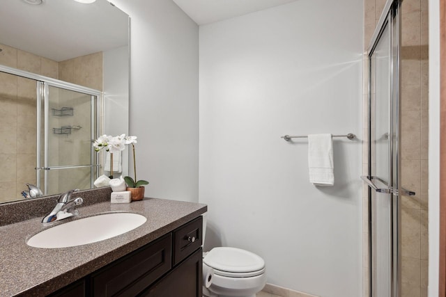 full bathroom featuring a shower stall, toilet, and vanity