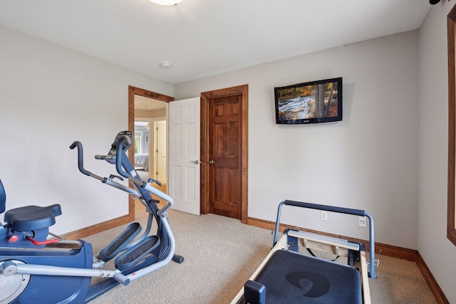 exercise room featuring carpet flooring and baseboards