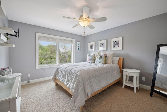 bedroom with a ceiling fan, baseboards, and carpet flooring