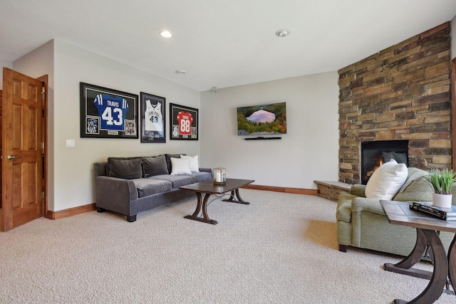 carpeted living room with a stone fireplace, recessed lighting, and baseboards