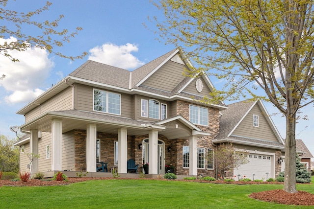 view of front of home with stone siding, a porch, and a front yard