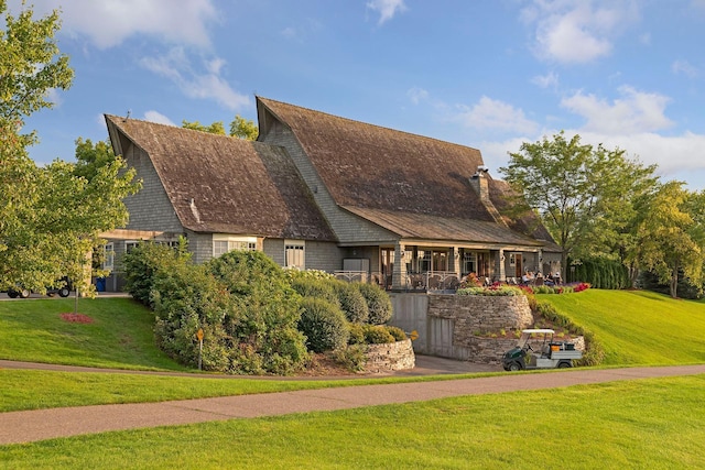 view of front of home with a front lawn and a chimney