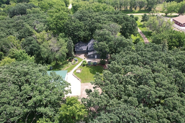 birds eye view of property with a view of trees