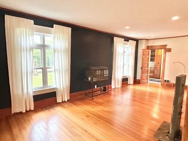 living room with crown molding, hardwood / wood-style flooring, and recessed lighting