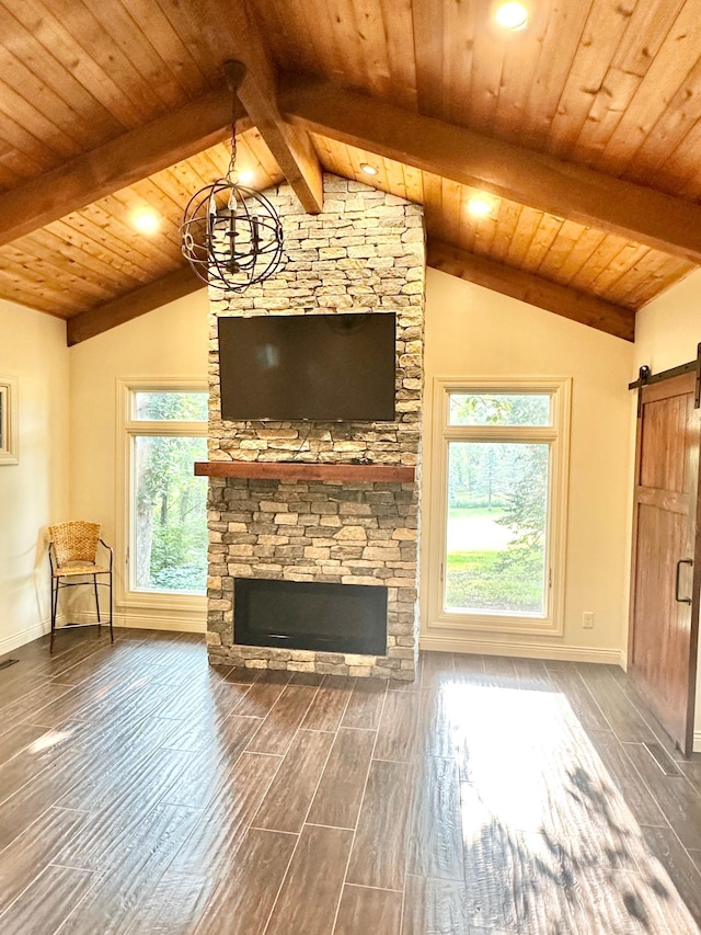 unfurnished living room featuring vaulted ceiling with beams, wood ceiling, hardwood / wood-style floors, and a barn door