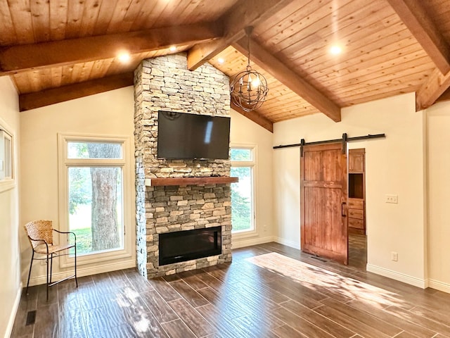 unfurnished living room featuring a barn door, plenty of natural light, and baseboards