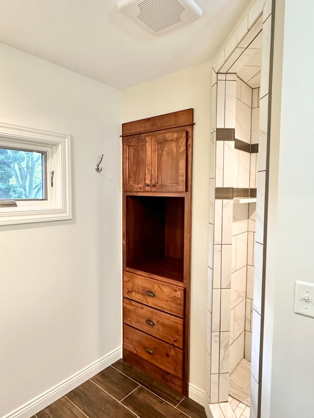 interior space featuring visible vents, wood finished floors, and baseboards