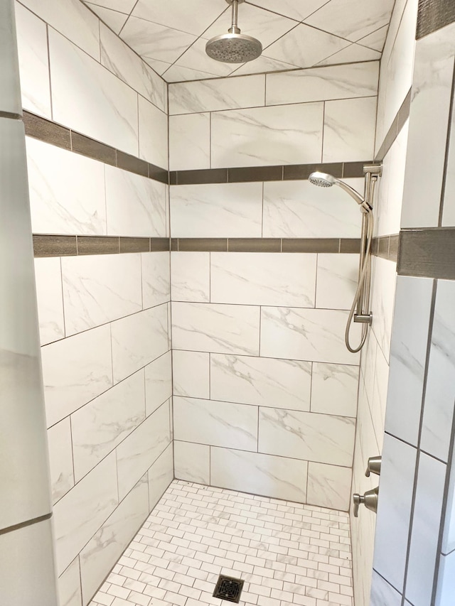 bathroom with tiled shower