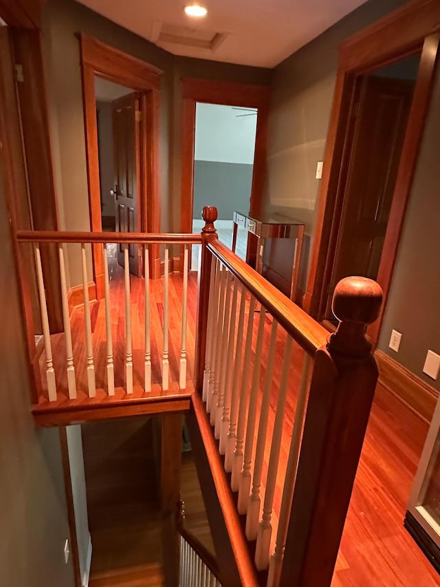 stairs with recessed lighting and wood finished floors