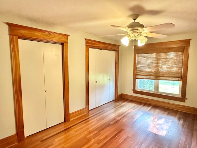 unfurnished bedroom with light wood-style flooring, baseboards, and ceiling fan